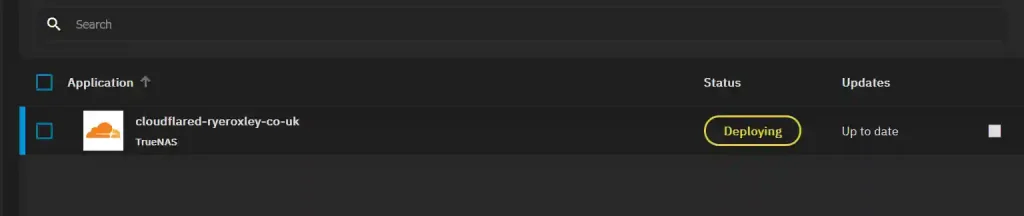The application 'cloudflared-ryeroxley-co-uk' from TrueNAS is currently deploying, with the status highlighted in yellow, and marked as 'Up to date'.